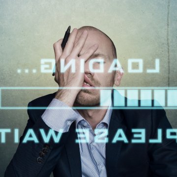 Guy clutching his face waiting for system to load